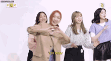 a group of young women are standing next to each other and one of them is saying oh wah