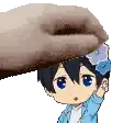 a hand is putting a flower on the head of a boy .