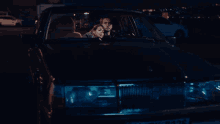 a man and a woman are sitting in a car that says volvo
