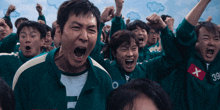 a group of people wearing green jackets with a red x on the front