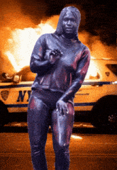 a woman standing in front of a police car that says ny