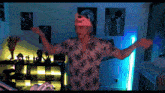 a man wearing a red bull hat is standing in a room
