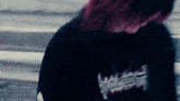a close up of a person wearing a black sweatshirt with the word war on it