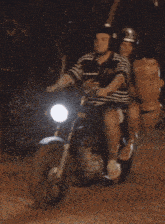 a man and woman are riding a motorcycle with a bag on the back