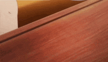 a wooden table with a white cup on top
