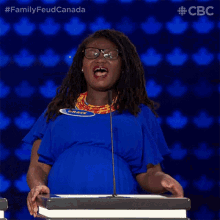 a woman stands at a podium with the name grace on her shirt