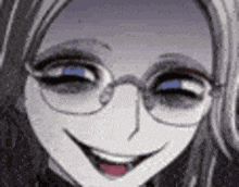 a close up of a woman 's face with glasses and a smile .