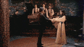a man and a woman are dancing in front of a band playing instruments