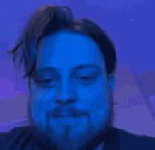 a close up of a man 's face with blue hair