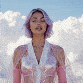 a woman with purple hair is wearing a pink top