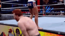 a man and a woman are wrestling in a wrestling ring