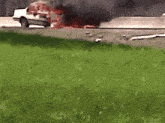 a car is on fire and smoke is coming out of the engine