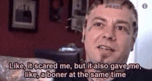 a man with a tattoo on his head is sitting on a couch and talking to the camera .
