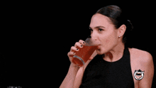 a woman holds a glass of beer in front of a cnn logo