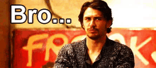a man with his arms crossed is standing in front of a sign that says bro