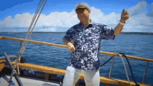 a man is dancing on a boat in the water