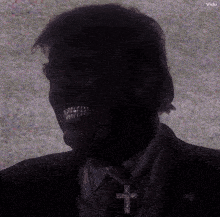 a silhouette of a man with a cross on his neck