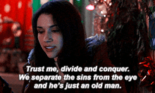 a woman in a dark room with a quote that says trust me divide and conquer