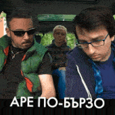 a man wearing glasses sits in the back seat of a car next to a woman wearing a plaid shirt