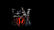 a blurry picture of a man playing drums with a drum set that says pearl on it