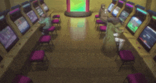 a row of arcade machines with a green screen in the background