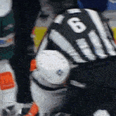 a hockey referee has the number 6 on his back