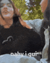 a woman is laying on a man 's lap with the words nahy i gui written on the bottom