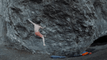 a man standing in front of a large rock with the words fucking bitch below him