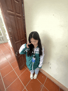 a girl wearing a lanyard that says ' aoc ' on it