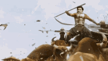 a man is riding a statue of a lion with a spear