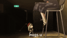 a person sitting on a chair next to a stuffed animal that says hugs u on it