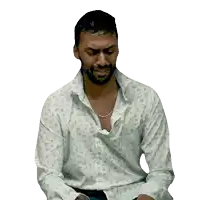 a man with a beard is wearing a white shirt that says ' x ' on it