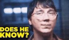 a close up of a man with glasses and the words does he know