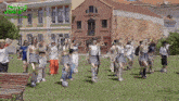 a group of people are dancing in front of a building with the words making jeans on it