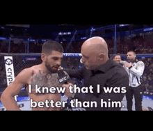 a man is talking to a fighter in a boxing ring while a referee looks on .