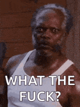 a man in a white tank top has the words what the fuck on his chest