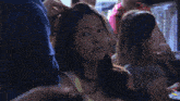 a woman with a surprised look on her face is in a crowd of people