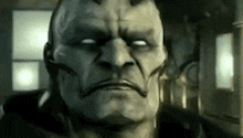 a close up of a man 's face with horns and a serious look on his face .