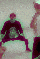 a man in a red shirt with a picture of a woman on it is kneeling down .