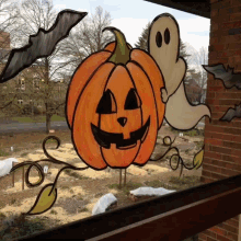 a drawing of a pumpkin and ghost on a window