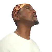 a man wearing a headband with the letter s on it smiles