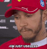 a man with a beard wearing a red hat says i 'm just useless ..