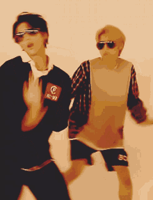 a man wearing sunglasses and a shirt that says ' sd ' on it is dancing with another man