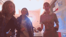 a group of girls are dancing in a room with a map on the wall