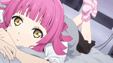 a girl with pink hair and striped socks is laying on a bed