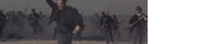 a blurred image of soldiers holding guns in a field