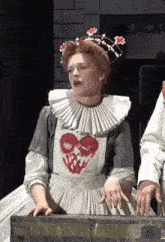 a woman in an apron with a heart on it