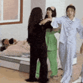 a group of women are standing next to each other in a room .