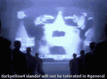 a group of people standing in front of a screen that says darkyellow4 slanderer will not be tolerated in #general