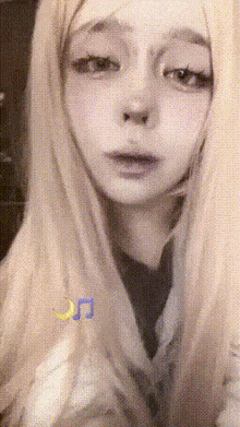 a close up of a woman 's face with a crescent moon behind her ear